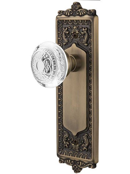 Egg and Dart Door Set with Matching Crystal-Glass Knobs in Antique Brass.